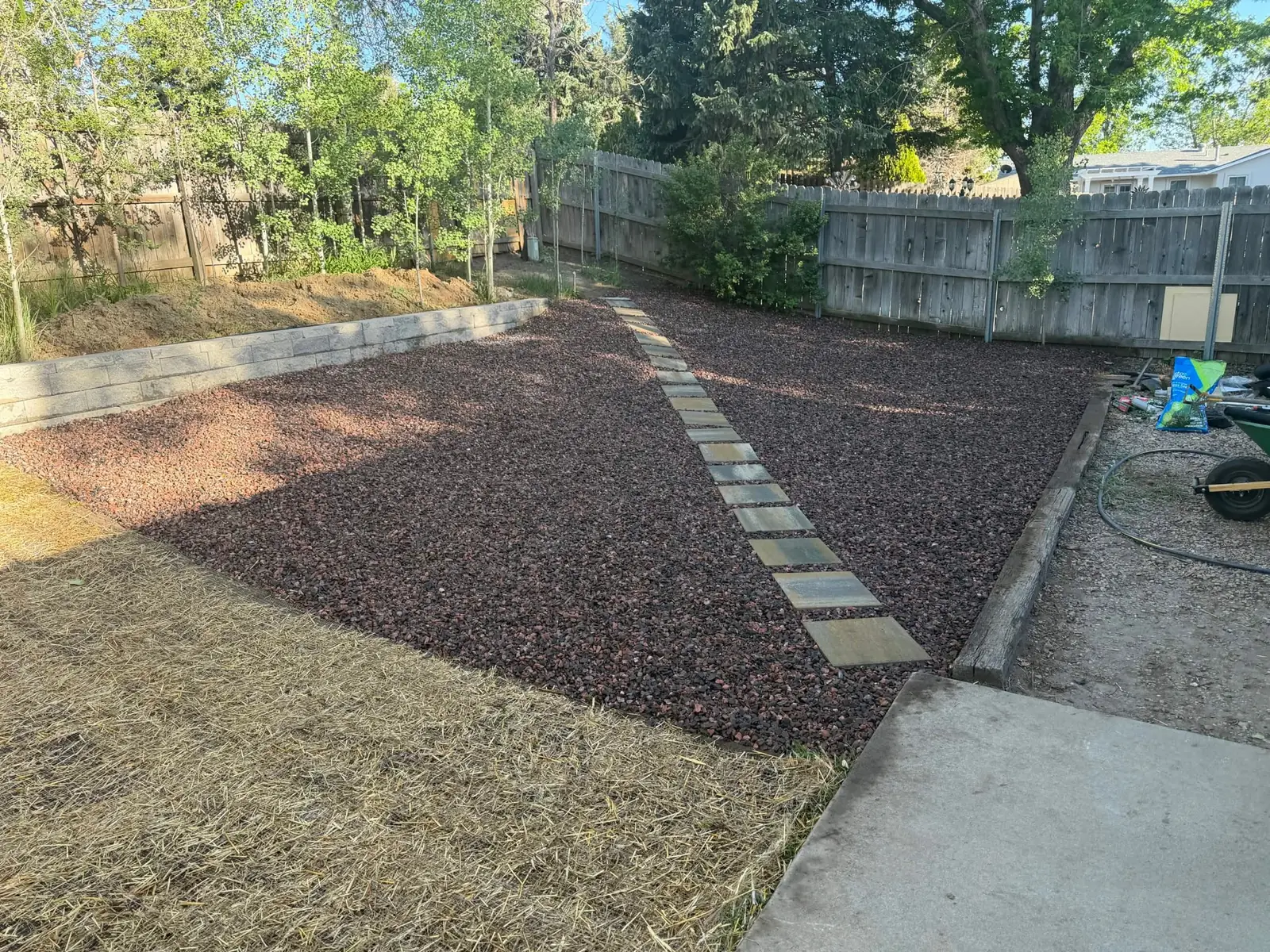 Decorative rock yard installation with a stepping-stone walkway