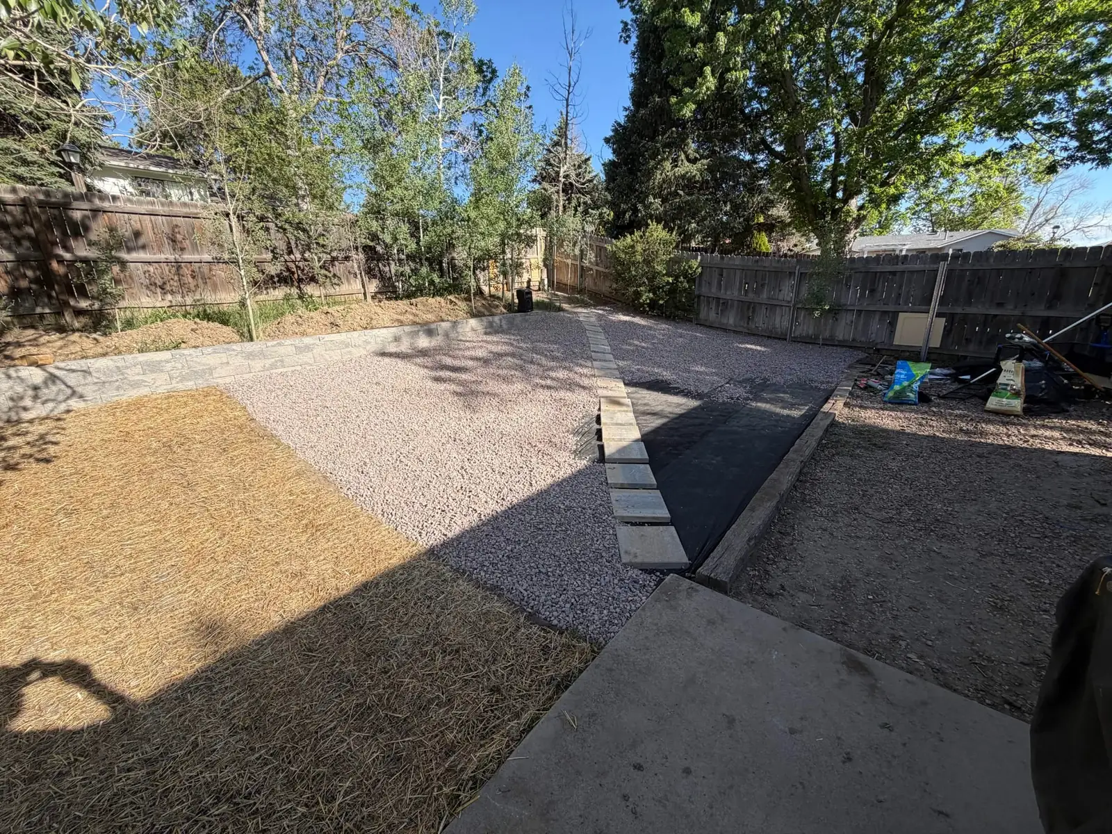 Decorative rock yard project with edging and landscape fabric installation